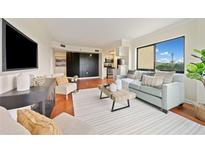 Bright living room features modern decor, hardwood floors, and large windows with a view at 795 Hammond Dr # 808, Sandy Springs, GA 30328