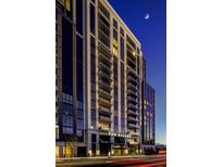 Elegant high-rise condo building featuring private balconies and modern architectural design against a twilight sky at 2425 Peachtree Ne Rd # 1505, Atlanta, GA 30305