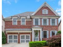 Charming two-story brick home with a two-car garage, manicured lawn, and inviting front entrance at 3467 Brookleigh Ne Ln, Atlanta, GA 30319