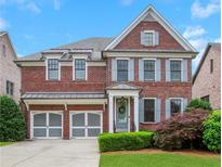 Charming two-story brick home with a two-car garage and well-maintained landscaping at 3467 Brookleigh Ne Ln, Atlanta, GA 30319