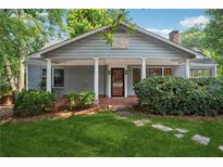 Charming home with a welcoming front porch, manicured lawn, and classic architectural details at 22 Peachtree Hills Ne Ave, Atlanta, GA 30305