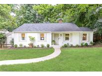 Charming, renovated one-story home with a manicured lawn and a welcoming walkway leading to the front door at 495 Hascall Nw Rd, Atlanta, GA 30309