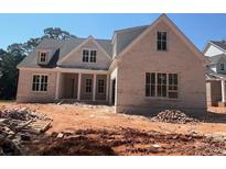 A charming brick two-story home with large windows and unfinished landscaping at 2759 S Waterworks Rd, Buford, GA 30518