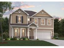 Charming two-story home boasts a two-car garage, manicured lawn, and traditional architectural details at 2645 Mourning Dove Drive (Lot 49), Grayson, GA 30017