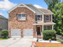 Charming two-story brick home with a two-car garage and manicured landscaping at 6018 Oakdale Se Rd, Mableton, GA 30126
