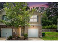 Charming townhome with brick accents, attached garage and inviting front yard at 3271 Pennington Dr, Stonecrest, GA 30038
