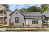 Charming single-Gathering home featuring a gray exterior, stylish front fence, and well-maintained landscaping at 752 Sw Cooper St Sw, Atlanta, GA 30315