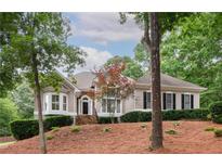 Charming home featuring manicured landscaping, bay windows and a welcoming front entry at 3750 Cannonwolde Dr, Snellville, GA 30039