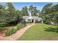 Charming single story home with manicured lawn and brick walkway at 167 Garden Ln, Decatur, GA 30030