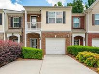 Charming multi-level townhome with brick accents, attached garage, and well-maintained landscaping at 2776 Snapfinger Mnr # 2776, Decatur, GA 30035