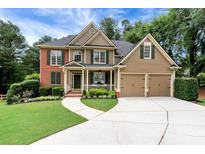 Charming two-story home featuring a manicured lawn, two-car garage, and inviting front porch at 28 Mcevers Branch Ct, Acworth, GA 30101