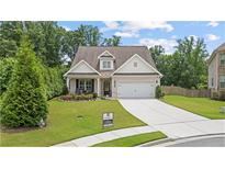 Charming brick front exterior featuring a well-manicured lawn and an attached two-car garage at 3392 Fall Branch Ln, Buford, GA 30519