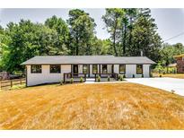 Charming renovated ranch-style home with white brick, dark trim, and a spacious front yard at 3122 Vandiver Dr, Marietta, GA 30066