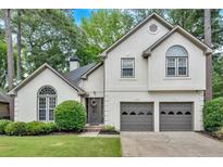 Charming traditional two-story home with a well-manicured lawn and an attached two-car garage at 3473 Whisperwood Nw Ct, Marietta, GA 30064