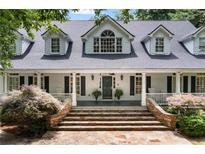 Charming two-story home featuring a welcoming front porch and stone staircase at 1824 Mount Paran Nw Rd, Atlanta, GA 30327