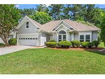 Charming single-story home with lush green lawn and well-maintained landscaping at 115 Graystone Terrace Ter, Alpharetta, GA 30005