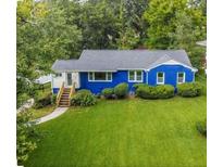Charming blue single-story home with well-manicured lawn and mature landscaping at 2011 Lexington Ave, Atlanta, GA 30344