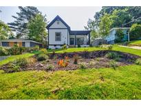 Charming remodeled home featuring a lush landscaped front yard with a covered porch at 115 Dahlia Nw Ave, Atlanta, GA 30314