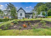 Charming two-story home featuring a landscaped front yard with an inviting curb appeal at 115 Dahlia Nw Ave, Atlanta, GA 30314