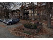 Multi-Gathering building featuring vintage facade, balconies, a tower detail, parking, and mature trees at 809 Camelot Dr # 809, College Park, GA 30349