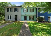 Charming townhome featuring colorful exterior, walkway, and inviting curb appeal at 732 Jamestown Xing, Jonesboro, GA 30238