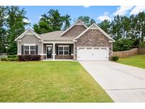 Charming single-Gathering home featuring a well-manicured lawn and inviting front entrance at 132 Berkleigh Trails Dr, Hiram, GA 30141