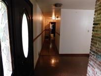 View of the long hallway featuring a decorative front door with detailed sidelight windows at 2765 Rollingwood Se Ln, Atlanta, GA 30316