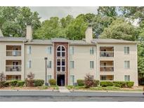 Attractive apartment building offering balconies, mature trees, and convenient parking at 591 Emory Oaks Way # 591, Decatur, GA 30033