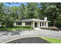 Charming home with a white exterior, a manicured lawn, and mature trees at 2676 Cottonwood Dr, Marietta, GA 30066