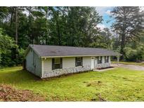 Charming single-story home featuring stone accents, a well-maintained lawn, and a covered carport at 3645 Shrewsbury Ct, Snellville, GA 30039