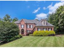Beautiful brick home with a manicured lawn and mature trees at 1155 Admiral Xing, Alpharetta, GA 30005