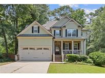 Charming two-story home with a two-car garage, landscaped yard, and inviting front porch perfect for relaxing at 3541 Wilton Ave, Atlanta, GA 30340