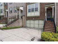 Charming townhomes with brick facade, attached garages, and inviting staircases at 1935 Cobblestone Ne Cir, Brookhaven, GA 30319