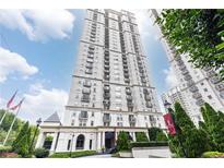 Luxury high-rise building featuring an elegant facade, manicured landscaping, and a welcoming entrance at 199 14Th Ne St # 412, Atlanta, GA 30309