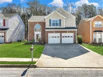 Charming two-story home with brick accents, well-manicured lawn, and a two-car garage at 2304 Stancrest Ln, Lawrenceville, GA 30044