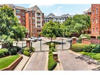 Beautiful exterior view of the luxurious condo building with manicured landscaping and gated entrance at 211 Colonial Homes Nw Dr # 1102, Atlanta, GA 30309