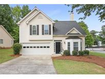 Charming home featuring a 2-car garage and a well-maintained front yard with mature landscaping at 2983 Albright Nw Commons, Kennesaw, GA 30144