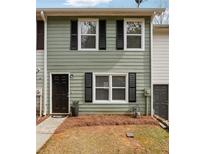 Charming townhouse with light green siding, black shutters, and a welcoming dark front door at 4282 Worth Nw St, Acworth, GA 30101