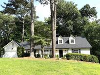 Charming single-story home with dormer windows, black shutters, and a well-manicured lawn at 229 Devonwood Drive Dr, Atlanta, GA 30328