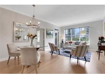 Bright living room with dining area, city views from the window, and stylish modern decor at 1101 Juniper Ne St # 619, Atlanta, GA 30309
