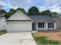 Charming single-story home featuring a two-car garage and a freshly painted facade with black shutters at 2470 Hillvale Cir, Lithonia, GA 30058