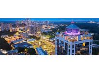 Stunning aerial view of the building's architectural design against the city skyline at twilight at 2828 Peachtree Nw Rd # P 3300, Atlanta, GA 30305