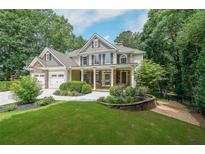 Charming two-story home with stone and siding, a well-manicured lawn, and a two car garage at 1403 Benbrooke Circle Northwest Nw Cir, Acworth, GA 30101