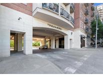 View of the Aramore building entrance with covered parking and upscale architectural details at 2277 Peachtree Ne Rd # 405, Atlanta, GA 30309