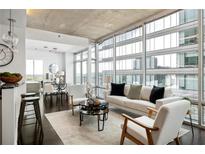Bright living room featuring floor to ceiling windows with city views at 923 Peachtree Ne St # 1238, Atlanta, GA 30309