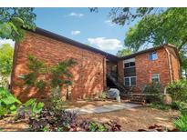 Apartment building featuring a brick exterior, stairs to the upper units, and a well-maintained yard with mature trees at 1284 Piedmont Ne Ave # 12, Atlanta, GA 30309