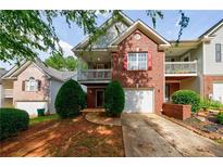 Charming two-story brick and siding home with a balcony and manicured landscaping at 1830 Broadway St, Decatur, GA 30035