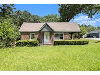 Charming brick home featuring a well-manicured lawn and mature trees at 3530 E Ponce De Leon Ave, Scottdale, GA 30079