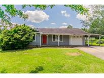 Charming single-story home with a well-maintained lawn and covered parking at 3217 Canterbury Trl, Rex, GA 30273