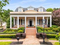 Charming home featuring a classic design, manicured landscaping, and inviting front porch at 3786 Turnberry Ct, Duluth, GA 30096